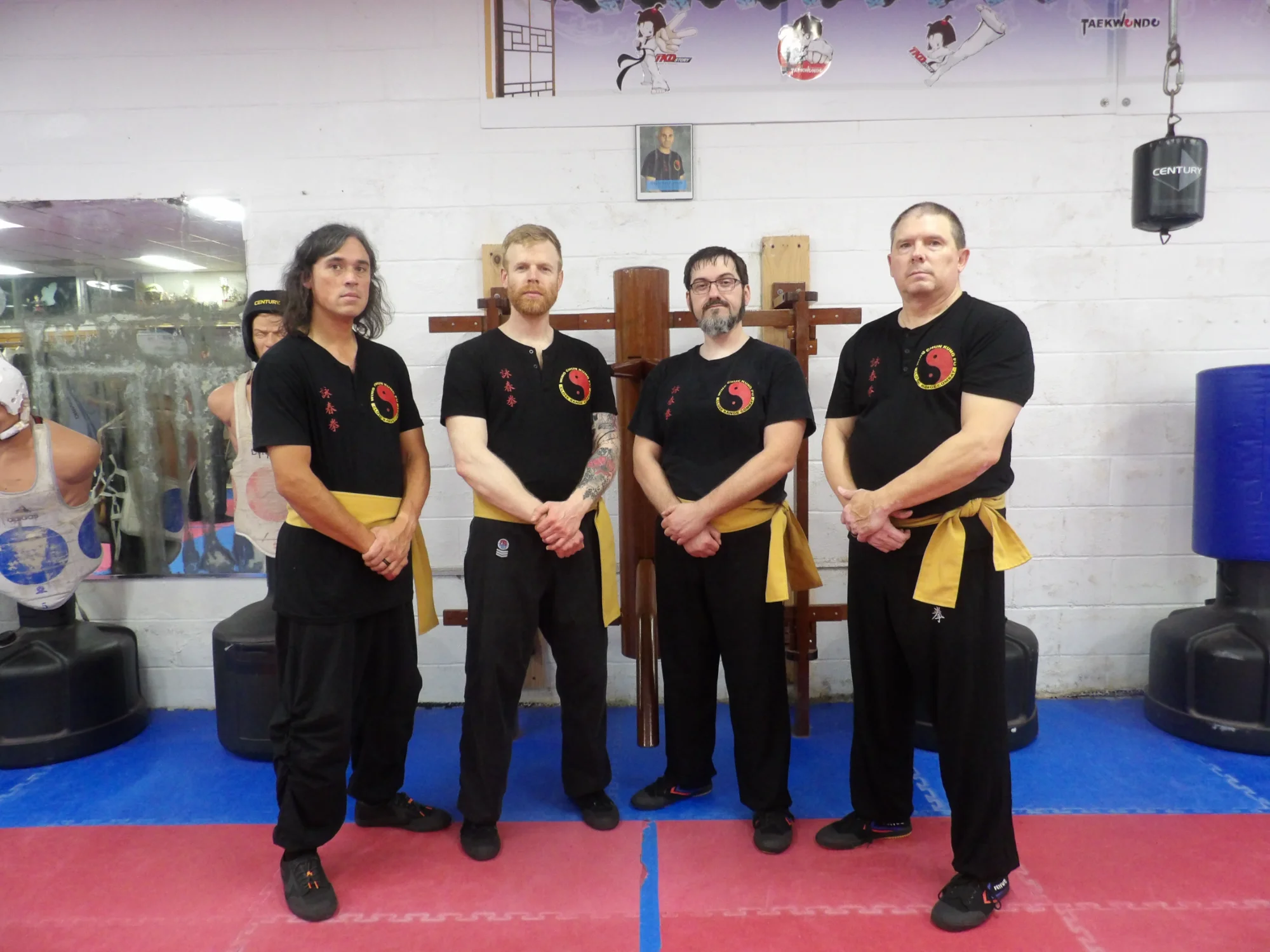 Wing Chun instructors with wooden dummy at Abingdon Maryland school